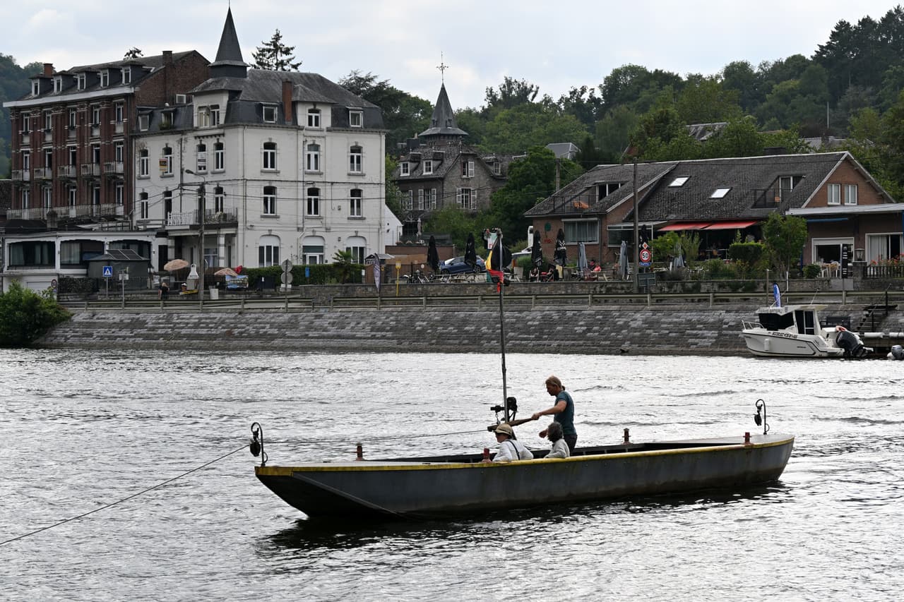 De handbediende veerpont van Waulsort op de Maas, met de veerman aan de kabel